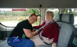 Annette is securing Sylvi Manttari's safety belt